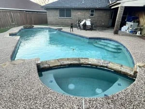 Renovated residential pool with new concrete decking and updated pool coping