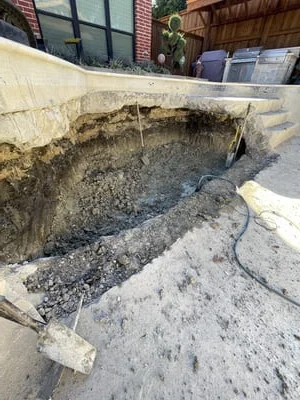 Excavated hardscape foundation with compacted soil base and wooden forms
